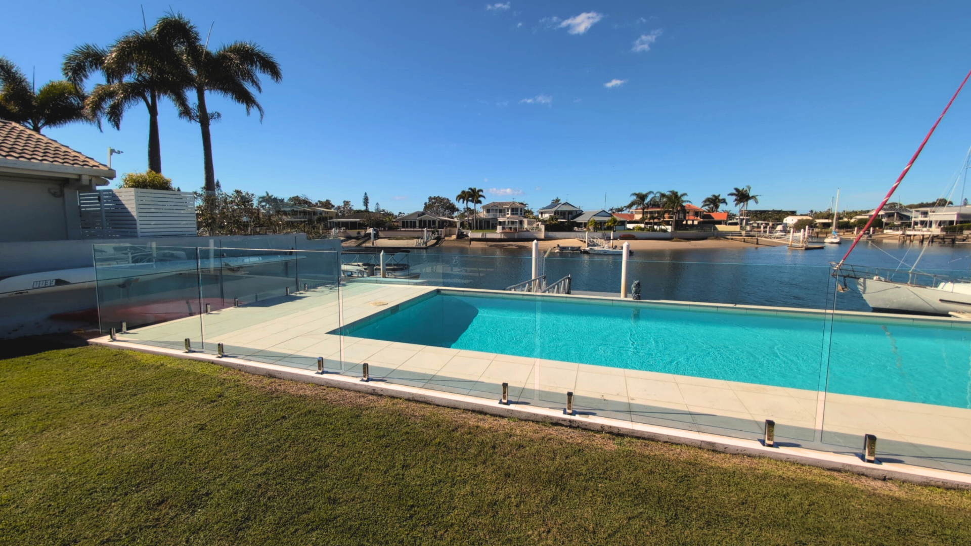 Frameless glass pool fence overlooking the canal