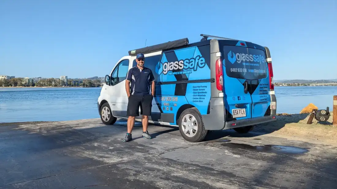 Paul standing in front of the GlassSafe van by the water